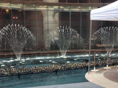 a group of fountains in a pool in a building at Vessel Hotel Fukuoka Kaizuka in Fukuoka