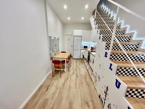a room with a table and a wine cellar at Oporto Blue Boavista - Deluxe City Center Duplex in Porto