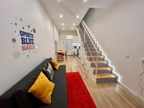 a living room with a couch and a staircase at Oporto Blue Boavista - Deluxe City Center Duplex in Porto