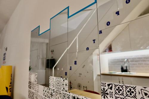 a room with a staircase with a mirror at Oporto Blue Boavista - Deluxe City Center Duplex in Porto