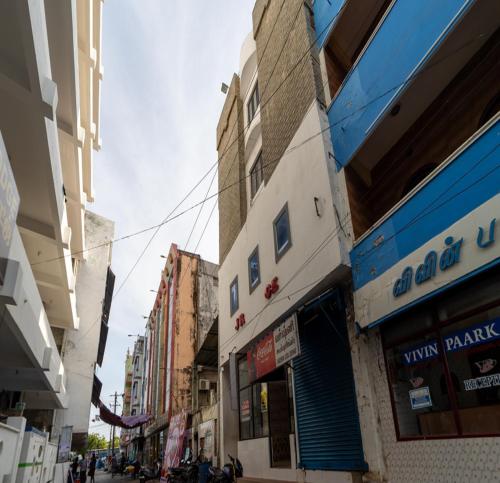 a group of buildings on a city street at JR Lodge in Velankanni