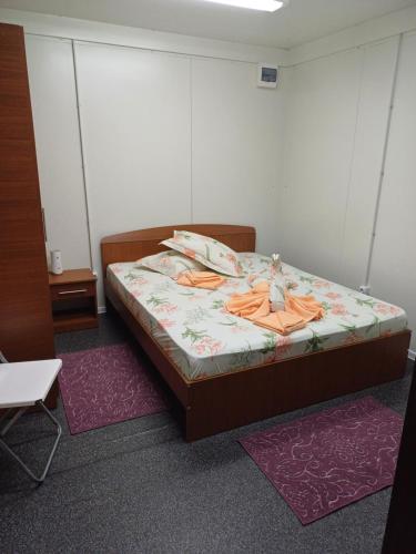 a bedroom with a bed with a doll on it at Monica și Tibo in Sfântu Gheorghe