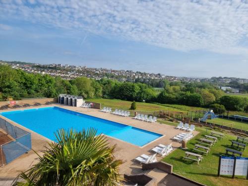 an overhead view of a swimming pool with lounge chairs at Static Caravan to Hire , Hoburne Devon Bay ( Paignton) in Goodrington