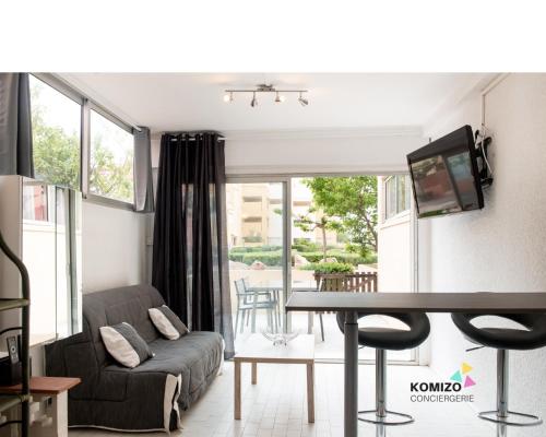 Il comprend un salon doté d'un canapé et d'une table avec une télévision. dans l'établissement Le Paradis caché, à Leucate