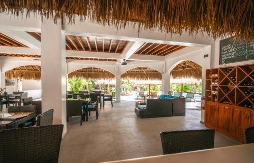 a restaurant with tables and chairs and a chalkboard at Secret paradise moalboal in Moalboal