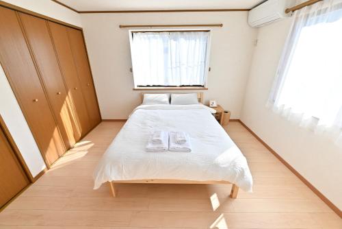a bedroom with a bed with two glasses on it at Private Villa Sinjuku -7min to 高田馬場駅 in Tokyo