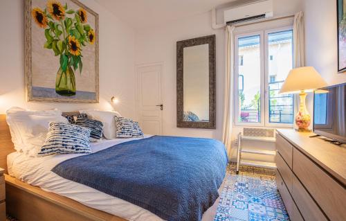 a bedroom with a bed with a vase of flowers at LA CIGALE by K6 Conciergerie Prestige in Cassis