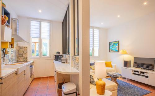 two views of a kitchen and a living room at LA CIGALE by K6 Conciergerie Prestige in Cassis