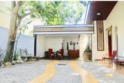 a building with a patio with a table and chairs at GiBu Art Gallery and Villa in Dehiwala