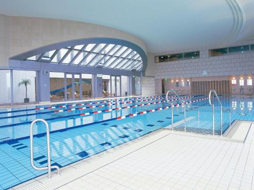 a large swimming pool in a large building at The Mark Grand Hotel in Saitama