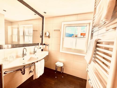 a bathroom with a sink and a mirror at Hotel Das Urbisgut in Altenmarkt im Pongau