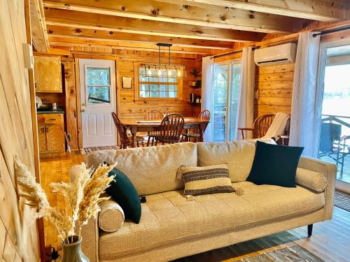 a living room with a couch and a table at Knotty Pines 4 Bedroom with Waterfront Views in Chelmsford