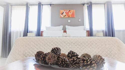 a plate of pine cones on a table in a bedroom at Nangoma Safari Lodge Lusaka in Lusaka
