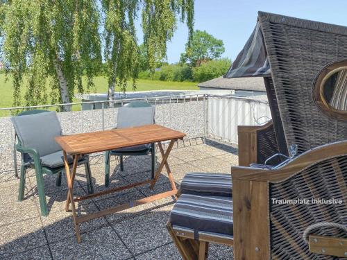 a table and two chairs and a table and a table and chairs at Ap Kiebitz - Haus Nordlichter in Wendtorf