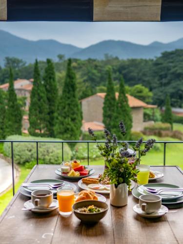 a table with plates of food and drinks on a balcony at La Toscana in Suan Phung