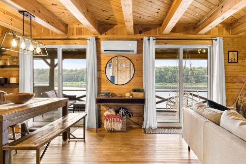 a living room with a couch and a table at Knotty Pines 4 Bedroom with Waterfront Views in Chelmsford