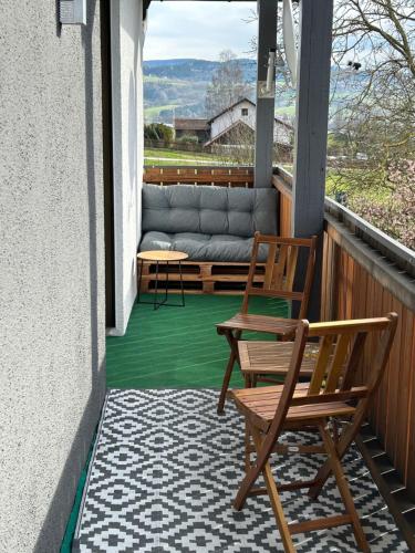 a porch with two chairs and a couch at Ferienwohnung Madera Campesina in Hunderdorf