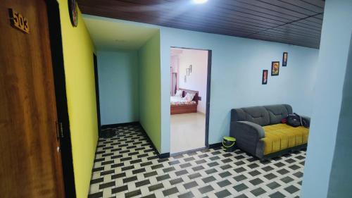a living room with a couch and a bedroom at BEACH STAYs in Revadanda