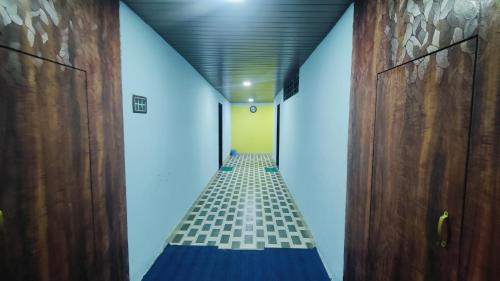 a hallway with a blue and white tile floor at BEACH STAYs in Revadanda