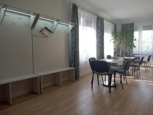 a dining room with a table and chairs at Noclegi PODZAMCZE PTTK in Przemyśl