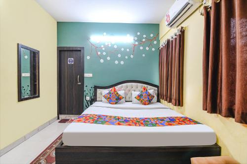 a bedroom with a large bed in a room at FabHotel Eco Inn in kolkata