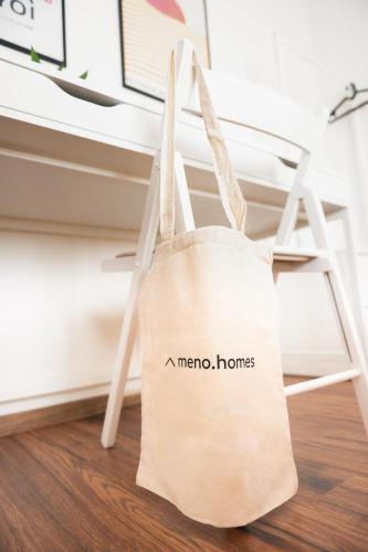 a mecca homes bag sitting on a desk at Harmony Stay in Xanthi Center with Parking - Meno Homes 6A in Xanthi