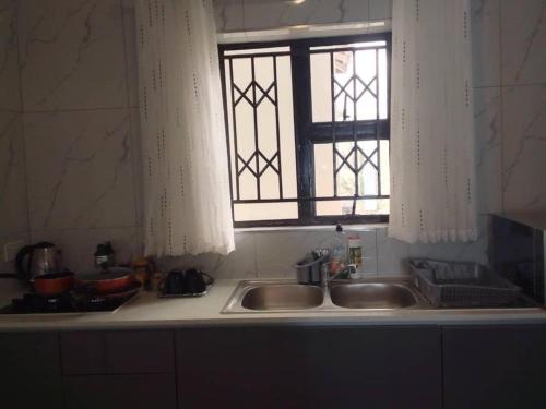 a kitchen sink with a window above it at Luxury 2 Bed Self Catering Apartment in Masvingo in Nyanda