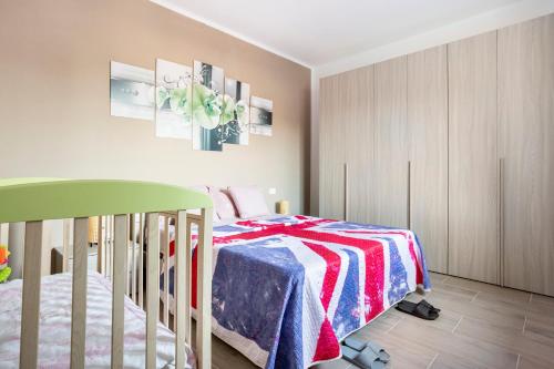 a bedroom with a crib and a bed at Baracca Apartment in Massa Lombarda