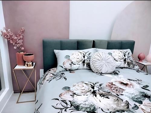 a bedroom with a bed with flowers on it at SUITE Corso Roma in Cerignola