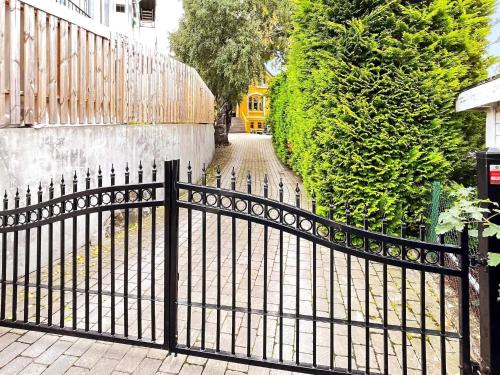 a black fence in front of a house at 10 person holiday home in arendal-By Traum in Arendal