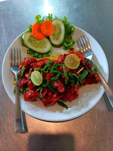 a plate of food on a table with fork and knife at Mountain View cafe in Pokhara