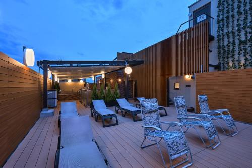 a patio with chairs and tables on a deck at Sauna & Capsule Hotel Rumor Plaza in Kyoto