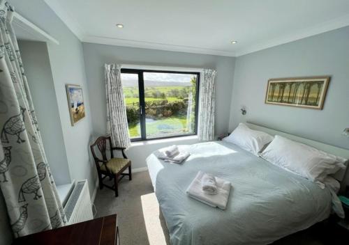 a bedroom with a bed with two towels on it at Heathlands in Carlton