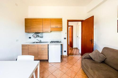 a living room with a couch and a kitchen at Agriturismo Giorgi appartamenti in Riviera Ligure in Albenga