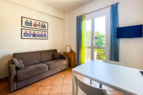 a living room with a couch and a table at Agriturismo Giorgi appartamenti in Riviera Ligure in Albenga