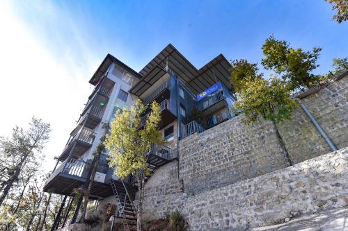 a building on top of a brick wall at FabExpress Neilkanth in Dhanaulti