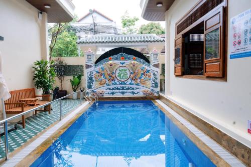 a pool in the middle of a building with a swimming pool at 1962 Garden Inn in Hue