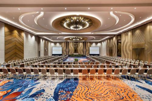 an empty conference room with chairs and a stage at MORAZEN Yogyakarta in Temon