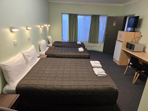 Ένα ή περισσότερα κρεβάτια σε δωμάτιο στο Lake Forbes Motel