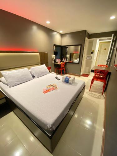 a bedroom with a bed and a table in it at Hotel Sogo - EDSA Trinoma in Manila