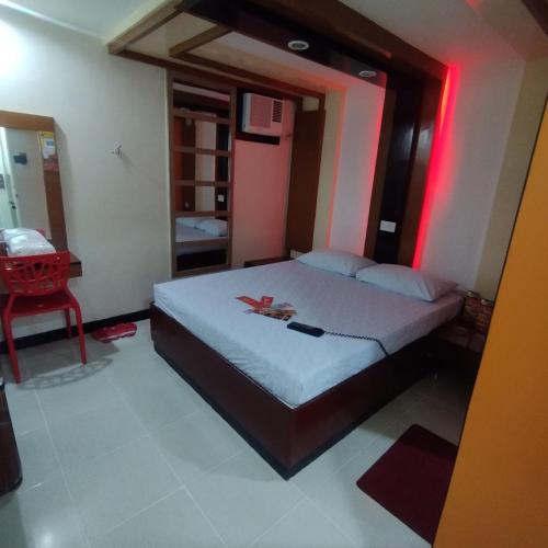 a bedroom with a bed with a red light at Hotel Sogo - Bagong Barrio, Caloocan in Manila