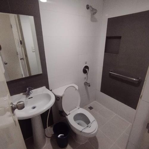 a bathroom with a toilet and a sink at Hotel Sogo - Bagong Barrio, Caloocan in Manila