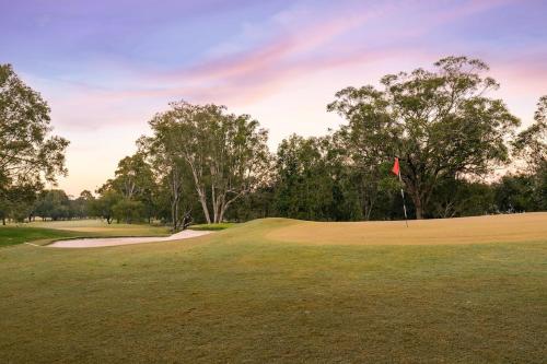 a view of a golf course with a green at Coffs Windmill Motel in Coffs Harbour