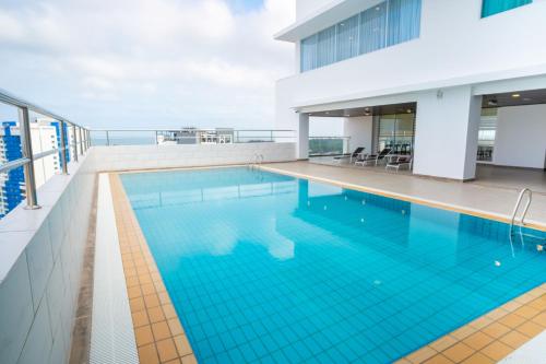 a swimming pool on the roof of a building at City Rise Hotel Miri in Miri