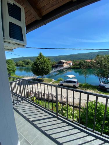 a view of a river from the balcony of a house at Apartman UnaTesnim in Bihać