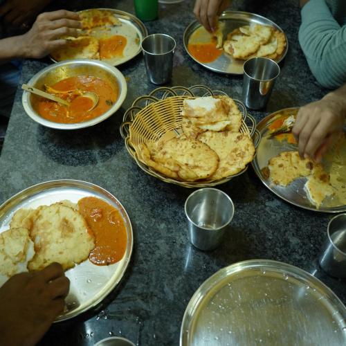 a table with plates of food on it at Hidden Valley Wayanad in Meppādi