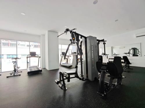 a gym with several treadmills and exercise bikes at Razak City Residence at Sungai Besi, Kuala Lumpur by Liberty Homes in Kuala Lumpur