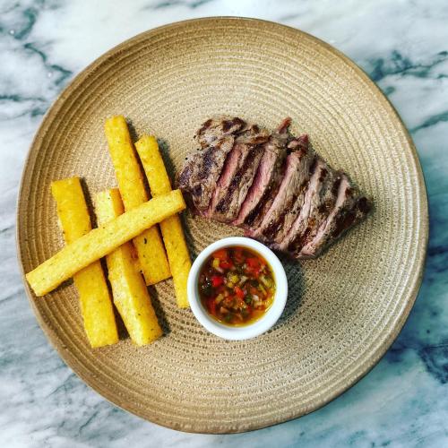 a plate with a steak and french fries and sauce at 19 Tile Ceramic Concept - by Unlock Hotels in Caldas da Rainha