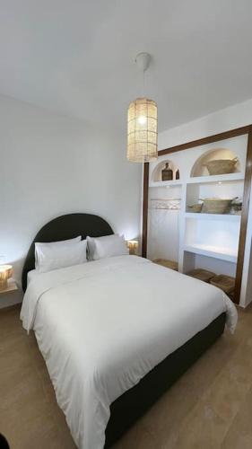 a bedroom with a large bed with a white bedspread at La Belle Vue !Bella Vista in Cabo Negro