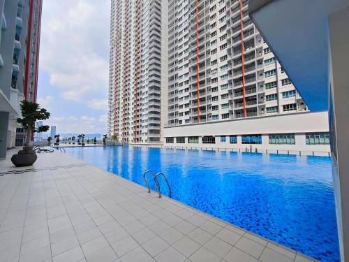 a swimming pool in front of a large building at Razak City Residence at Sungai Besi, Kuala Lumpur by Liberty Homes in Kuala Lumpur